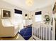 Cozy Bedroom with a crib, glider, and charming decor, perfect for a baby at 2419 N Park Ave, Indianapolis, IN 46205