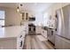 Bright kitchen with white cabinets, stainless steel appliances, a farmhouse sink, and contemporary light fixtures at 2419 N Park Ave, Indianapolis, IN 46205