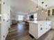 Well-lit kitchen featuring white cabinetry, stainless steel appliances, an island with seating, and an open layout at 2419 N Park Ave, Indianapolis, IN 46205