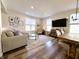 Spacious living room with neutral decor, a modern rug, large windows, and a seamless flow into the dining area at 2419 N Park Ave, Indianapolis, IN 46205