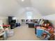 Spacious playroom with a comfortable gray sofa, TV, and kitchen set at 2419 N Park Ave, Indianapolis, IN 46205