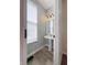 Stylish powder room with pedestal sink, modern fixtures, and natural light at 2419 N Park Ave, Indianapolis, IN 46205