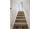 Carpeted staircase with white railing leading to the upper level of the home at 2419 N Park Ave, Indianapolis, IN 46205