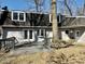 The backyard has a deck and is surrounded by mature trees providing ample shade at 2605 W Berkshire Dr, Muncie, IN 47304