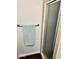 Cozy bathroom showcasing a shower stall with glass doors and dark wooden vinyl floors at 2605 W Berkshire Dr, Muncie, IN 47304