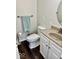 Well-lit bathroom with a white toilet, granite vanity, and vinyl floors at 2605 W Berkshire Dr, Muncie, IN 47304