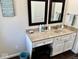 Bathroom featuring a granite vanity with makeup table and dark wood floors at 2605 W Berkshire Dr, Muncie, IN 47304