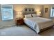 Inviting bedroom featuring a large window, carpeted floors, a comfy king bed, and bedside tables at 2605 W Berkshire Dr, Muncie, IN 47304