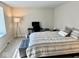 Comfortable bedroom with a plush bed, desk, and floor lamp offering a relaxing retreat at 2605 W Berkshire Dr, Muncie, IN 47304