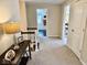 Spacious hallway with carpet, featuring a table and open doorways into other rooms at 2605 W Berkshire Dr, Muncie, IN 47304
