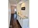 Hallway featuring a granite countertop and cabinetry with a view into the dining room at 2605 W Berkshire Dr, Muncie, IN 47304