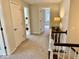Carpeted second story hallway with wood trim, white doors, and a table topped with a lamp at 2605 W Berkshire Dr, Muncie, IN 47304