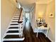 Inviting home hallway with stylish wood floors and a staircase at 2605 W Berkshire Dr, Muncie, IN 47304