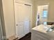 Convenient laundry room with a side-by-side washer and dryer, closet, and lovely dark wood floors at 2605 W Berkshire Dr, Muncie, IN 47304
