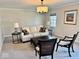 Cozy living room with a comfortable sofa, stylish chairs, and natural lighting at 2605 W Berkshire Dr, Muncie, IN 47304