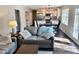 A cozy living room with hardwood floors and a view into the eat-in kitchen at 2605 W Berkshire Dr, Muncie, IN 47304