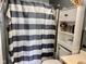 Cozy bathroom featuring striped shower curtain, shelving, and decorative accents for a personal touch at 2715 S 300 E, Anderson, IN 46017