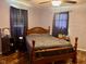 Comfortable bedroom features a wooden bed frame and hardwood floors, offering a peaceful retreat at 2715 S 300 E, Anderson, IN 46017