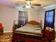 Comfortable bedroom features a wooden bed frame and hardwood floors, offering a peaceful retreat at 2715 S 300 E, Anderson, IN 46017