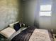 Modern bedroom features a dark accent wall and plush bedding for a relaxing and stylish space at 2715 S 300 E, Anderson, IN 46017