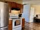 Traditional-style kitchen with stainless steel appliances, wood cabinets, and a white range and oven at 2715 S 300 E, Anderson, IN 46017