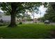 Well-maintained backyard featuring lush greenery, mature trees, and partial fencing for added privacy at 3140 Bonham Dr, Indianapolis, IN 46222