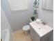 Bathroom with a gray vanity, white sink, and a toilet at 3140 Bonham Dr, Indianapolis, IN 46222
