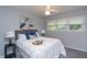 Cozy bedroom with a queen-sized bed, soft white linens, plush pillows, and a window letting in natural light at 3140 Bonham Dr, Indianapolis, IN 46222