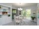 Bright dining area with a modern chandelier, white table, and sliding doors to the backyard at 3140 Bonham Dr, Indianapolis, IN 46222