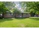 Ranch-style home with a well-kept lawn and mature shade trees in a suburban setting at 3140 Bonham Dr, Indianapolis, IN 46222