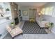 Bright living room featuring a stone fireplace, comfortable sofa, patterned rug, and built-in shelving at 3140 Bonham Dr, Indianapolis, IN 46222