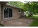 View of patio with glass sliding door, with stone exterior and an adjacent air conditioning unit at 3140 Bonham Dr, Indianapolis, IN 46222