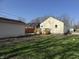 Back of house, showing the wood deck and lush yard at 3233 N Tacoma Ave, Indianapolis, IN 46218