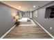 A bedroom with wood flooring, gray walls, and a large bed with decorative pillows and a throw blanket at 3233 N Tacoma Ave, Indianapolis, IN 46218