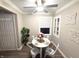 Cozy dining room with white table, four chairs, ceiling fan, and access door at 3233 N Tacoma Ave, Indianapolis, IN 46218
