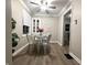 Cozy dining room with white table, four chairs, ceiling fan and natural light at 3233 N Tacoma Ave, Indianapolis, IN 46218