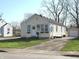 Charming home exterior featuring a wreath on the front door, cozy window planters, and a long driveway at 3233 N Tacoma Ave, Indianapolis, IN 46218