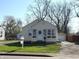 Charming home exterior featuring a wreath on the front door, cozy window planters, and a long driveway at 3233 N Tacoma Ave, Indianapolis, IN 46218