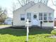 Charming home exterior featuring a wreath on the front door and cozy window planters at 3233 N Tacoma Ave, Indianapolis, IN 46218