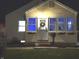 Charming home exterior featuring a wreath on the front door and cozy window planters at nighttime at 3233 N Tacoma Ave, Indianapolis, IN 46218