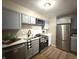 Bright kitchen features stainless steel appliances, white countertops, and grey cabinets at 3233 N Tacoma Ave, Indianapolis, IN 46218