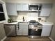 Bright kitchen features stainless steel appliances, white countertops, and grey cabinets at 3233 N Tacoma Ave, Indianapolis, IN 46218