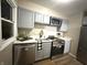 Bright kitchen features stainless steel appliances, white countertops, and grey cabinets at 3233 N Tacoma Ave, Indianapolis, IN 46218