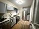 Bright kitchen features stainless steel appliances, white countertops, and grey cabinets at 3233 N Tacoma Ave, Indianapolis, IN 46218