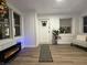 Bright living room featuring white wainscoting, light wood floors, and an electric fireplace at 3233 N Tacoma Ave, Indianapolis, IN 46218