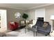 Cozy living room with gray sofa, accent chairs, glass table and light gray walls at 3233 N Tacoma Ave, Indianapolis, IN 46218