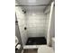Close up of shower, featuring a hexagon-tile shower floor, and vertical rectangular wall tiles at 3233 N Tacoma Ave, Indianapolis, IN 46218