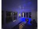 Cozy sunroom with an electric fireplace, multiple windows, and bright lighting at nighttime at 3233 N Tacoma Ave, Indianapolis, IN 46218