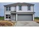 Charming two-story home features gray siding, a gray garage door, and modern windows at 3276 W Longbranch Dr, Monrovia, IN 46157