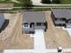 Aerial view of two-story house with gray roof and white garage door on a construction lot with a light-colored driveway at 3315 Godby Dr, Sheridan, IN 46069